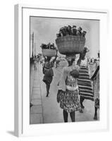 Nigerian Women with Babies Strapped to Their Backs Carrying Large Baskets on Their Heads-Alfred Eisenstaedt-Framed Photographic Print