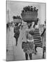 Nigerian Women with Babies Strapped to Their Backs Carrying Large Baskets on Their Heads-Alfred Eisenstaedt-Mounted Photographic Print