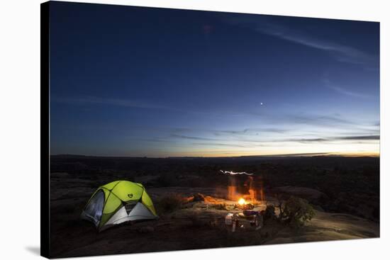 Night Camping Scene with Lit Up Tent and Campfire. Moab, Utah-Matt Jones-Stretched Canvas