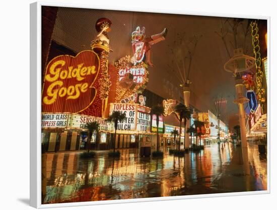Night Reflections on Wet Street of Neon Signs Along Fremont Street in Las Vegas, Nevada, USA-null-Framed Photographic Print