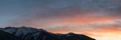 Panorama Seen from Sunset Through a Cairn on Pirchkogel with Snow, Summit Cross and Prayer Flags-Niki Haselwanter-Photographic Print