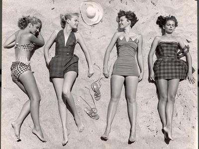 Models Sunbathing, Wearing Latest Beach Fashions