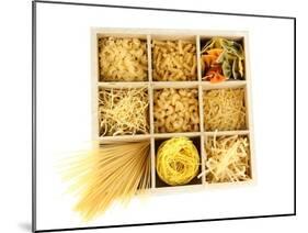 Nine Types Of Pasta In Wooden Box Sections Isolated On White-Yastremska-Mounted Art Print