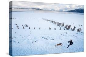 Noelle Zmuda And Her Dog Tink Go For A Cold Winter Run On Pond Oreille Bay Trail, Sandpoint, Idaho-Ben Herndon-Stretched Canvas