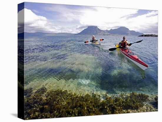 Nordland, Helgeland, Sea Kayakers Explore Calm Coastal Waters of Southern Nordland, Norway-Mark Hannaford-Stretched Canvas