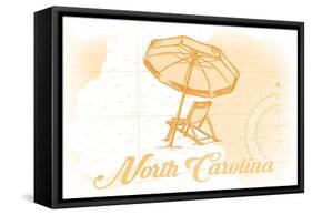 North Carolina - Beach Chair and Umbrella - Yellow - Coastal Icon-Lantern Press-Framed Stretched Canvas