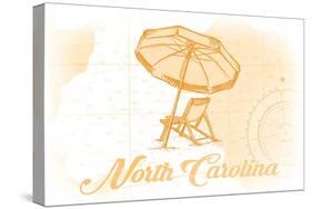 North Carolina - Beach Chair and Umbrella - Yellow - Coastal Icon-Lantern Press-Stretched Canvas