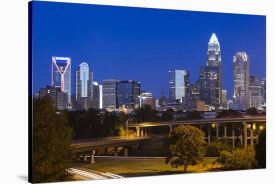 North Carolina, Charlotte, Elevated View of the City Skyline at Dawn-Walter Bibikow-Stretched Canvas