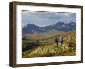 North Wales, Snowdonia; a Man and Woman Stop to Look at their Map Whilst Hiking in Snowdonia;-John Warburton-lee-Framed Photographic Print