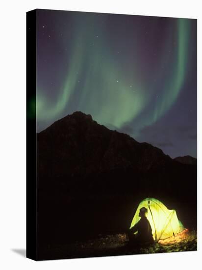Northern Lights and Camper Outside Tent, Brooks Range, Arctic National Wildlife Refuge, Alaska, USA-Steve Kazlowski-Stretched Canvas