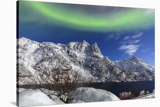 Northern Lights (Aurora Borealis) Illuminate the Snowy Peaks and the Blue Sky During a Starry Night-Roberto Moiola-Stretched Canvas