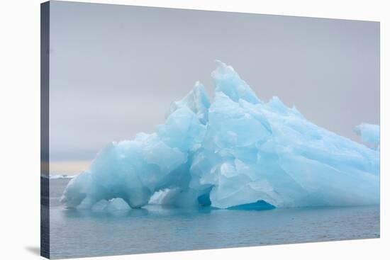 Norway. Svalbard. Brasvelbreen. Turquoise Ice Bergs in the Calm Water-Inger Hogstrom-Stretched Canvas