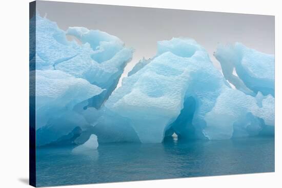 Norway. Svalbard. Brasvelbreen. Turquoise Ice Bergs in the Calm Water-Inger Hogstrom-Stretched Canvas