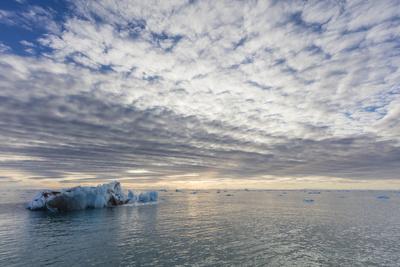 https://imgc.allpostersimages.com/img/posters/norway-svalbard-nordaustlandet-cloud-patterns-and-ocean-ice-at-sunrise_u-L-Q13ANDP0.jpg?artPerspective=n