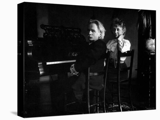 Norwegian Composer Edvard Grieg with His Wife Seated in Front of a Piano-null-Stretched Canvas