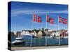 Norwegian Flags and Historic Harbour Warehouses, Stavanger, Norway, Scandinavia, Europe-Christian Kober-Stretched Canvas