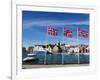 Norwegian Flags and Historic Harbour Warehouses, Stavanger, Norway, Scandinavia, Europe-Christian Kober-Framed Photographic Print