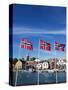Norwegian Flags and Historic Harbour Warehouses, Stavanger, Norway, Scandinavia, Europe-Christian Kober-Stretched Canvas