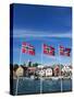 Norwegian Flags and Historic Harbour Warehouses, Stavanger, Norway, Scandinavia, Europe-Christian Kober-Stretched Canvas