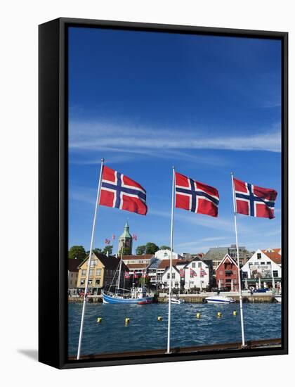 Norwegian Flags and Historic Harbour Warehouses, Stavanger, Norway, Scandinavia, Europe-Christian Kober-Framed Stretched Canvas