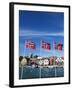 Norwegian Flags and Historic Harbour Warehouses, Stavanger, Norway, Scandinavia, Europe-Christian Kober-Framed Photographic Print