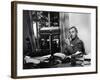 Novelist and Script Writer William Faulkner Smoking a Pipe at His Desk at Warner Brothers Studios-null-Framed Premium Photographic Print