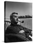 Novelist and Script Writer William Faulkner Smoking a Pipe on the Balcony of His Hotel Room-null-Stretched Canvas