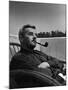 Novelist and Script Writer William Faulkner Smoking a Pipe on the Balcony of His Hotel Room-null-Mounted Premium Photographic Print