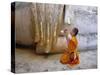 Novice Buddhist Monk Kneeling Beneath the Phra Atchana Buddha Statue, Sukhothai Province, Thailand-Gavin Hellier-Stretched Canvas