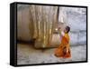 Novice Buddhist Monk Kneeling Beneath the Phra Atchana Buddha Statue, Sukhothai Province, Thailand-Gavin Hellier-Framed Stretched Canvas