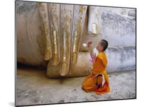 Novice Buddhist Monk Kneeling Beneath the Phra Atchana Buddha Statue, Sukhothai Province, Thailand-Gavin Hellier-Mounted Photographic Print