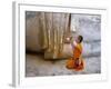 Novice Buddhist Monk Kneeling Beneath the Phra Atchana Buddha Statue, Sukhothai Province, Thailand-Gavin Hellier-Framed Photographic Print