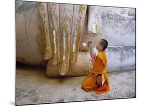 Novice Buddhist Monk Kneeling Beneath the Phra Atchana Buddha Statue, Sukhothai Province, Thailand-Gavin Hellier-Mounted Photographic Print