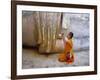 Novice Buddhist Monk Kneeling Beneath the Phra Atchana Buddha Statue, Sukhothai Province, Thailand-Gavin Hellier-Framed Photographic Print