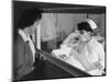 Nurse Aiko Hamaguchi shows new baby to mother in maternity ward, Manzanar War Relocation Center, CA-Ansel Adams-Mounted Photographic Print