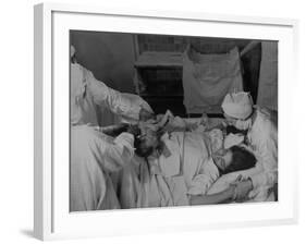 Nurse at Her Head and Holding Her Hands, as She Gazes at Her Baby Boy after "Painless" Childbirth-Alfred Eisenstaedt-Framed Premium Photographic Print