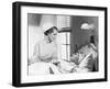 Nurse Comforts a Patient in a Hospital Bed, Talking to Each Other-null-Framed Photo