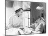 Nurse Comforts a Patient in a Hospital Bed, Talking to Each Other-null-Mounted Photo