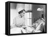 Nurse Comforts a Patient in a Hospital Bed, Talking to Each Other-null-Framed Stretched Canvas
