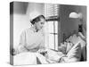 Nurse Comforts a Patient in a Hospital Bed, Talking to Each Other-null-Stretched Canvas