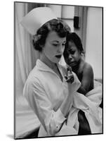 Nurse Holding African American Girl in Her Arms, Examining Her Finger-John Dominis-Mounted Photographic Print