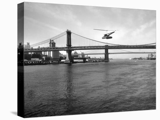 NYC Police Helicopter Hovering over the East River Next to the Manhattan Bridge-null-Stretched Canvas