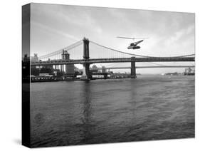 NYC Police Helicopter Hovering over the East River Next to the Manhattan Bridge-null-Stretched Canvas