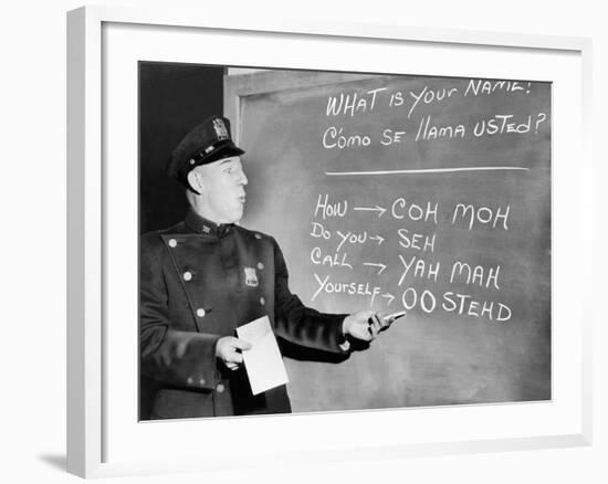 NYC Police Officer Practices Basic Spanish Phrases Written on Blackboard, Ca. 1955-null-Framed Photo