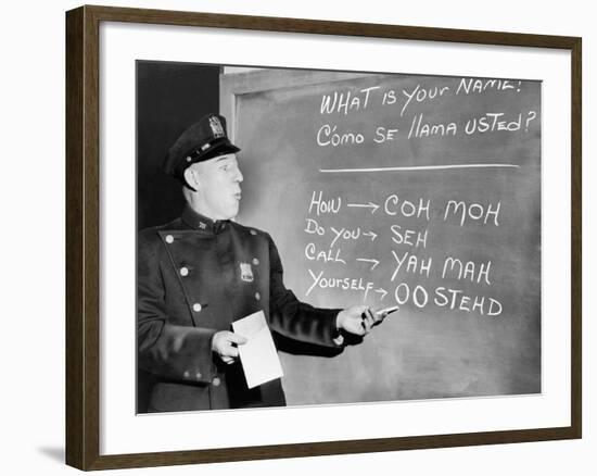 NYC Police Officer Practices Basic Spanish Phrases Written on Blackboard, Ca. 1955-null-Framed Photo