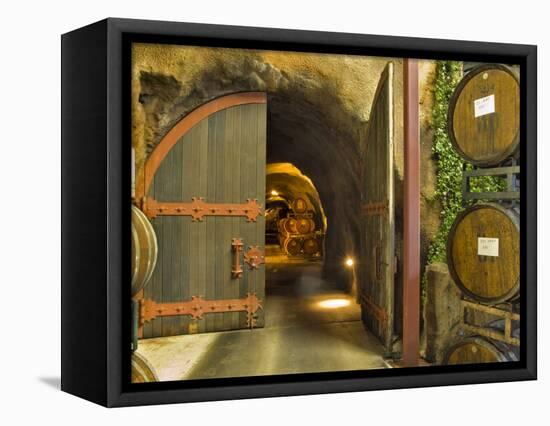 Oak Barrels Stacked Outside of Open Door To Aging Caves at Ironstone Winery, California, USA-Janis Miglavs-Framed Stretched Canvas