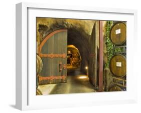Oak Barrels Stacked Outside of Open Door To Aging Caves at Ironstone Winery, California, USA-Janis Miglavs-Framed Photographic Print