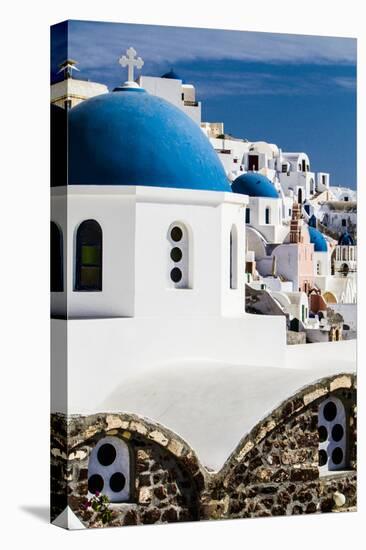 Oia, Greece. Row of Greek Orthodox Churches with blue domes.-Jolly Sienda-Stretched Canvas