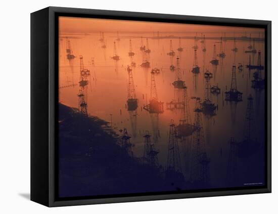 Oil Rigs Dating from the 1920's Dot the Shallows of Galveston Bay-Ralph Crane-Framed Stretched Canvas