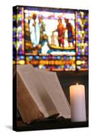 Old Bible and church candle, Carouge Protestant temple, Geneva, Switzerland-Godong-Stretched Canvas